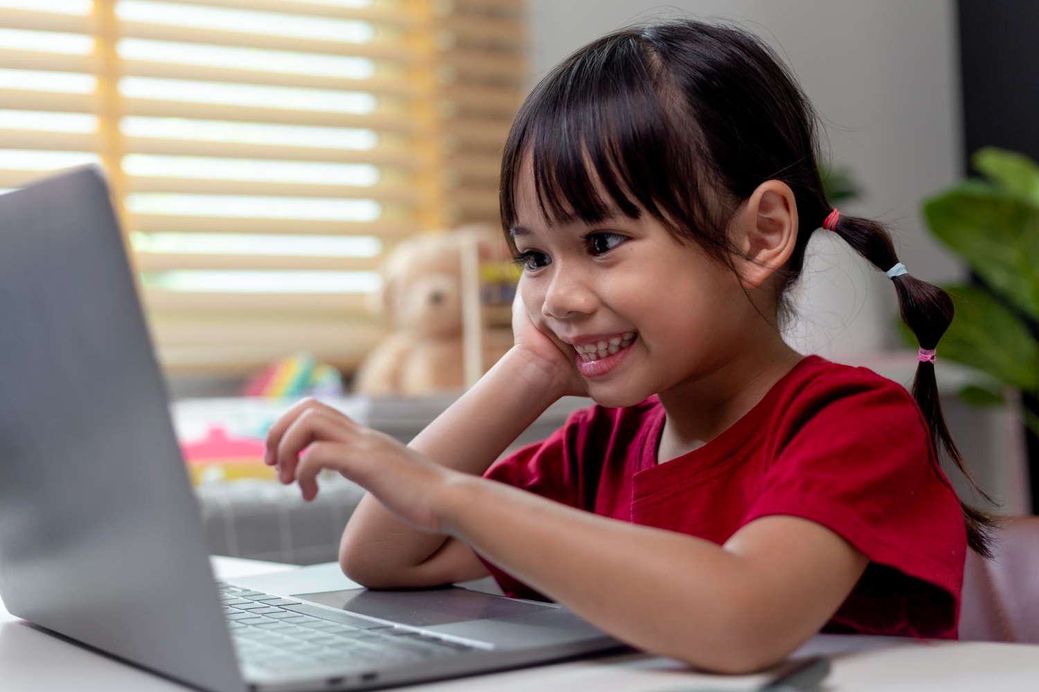 Kid working on laptop happily