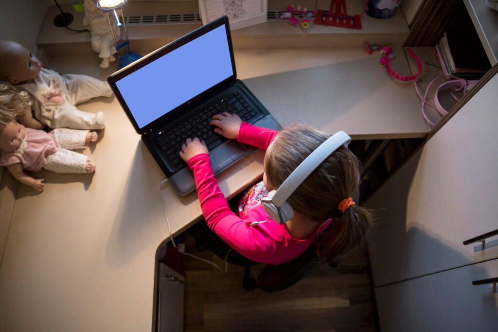 girl using laptop in small room